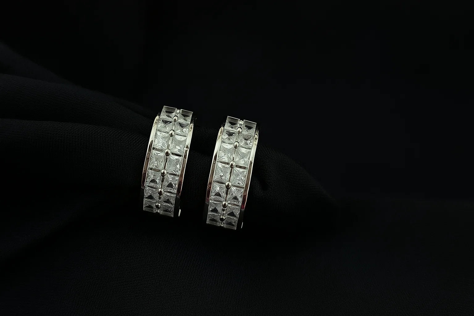 Pair of diamond earrings on a black background
